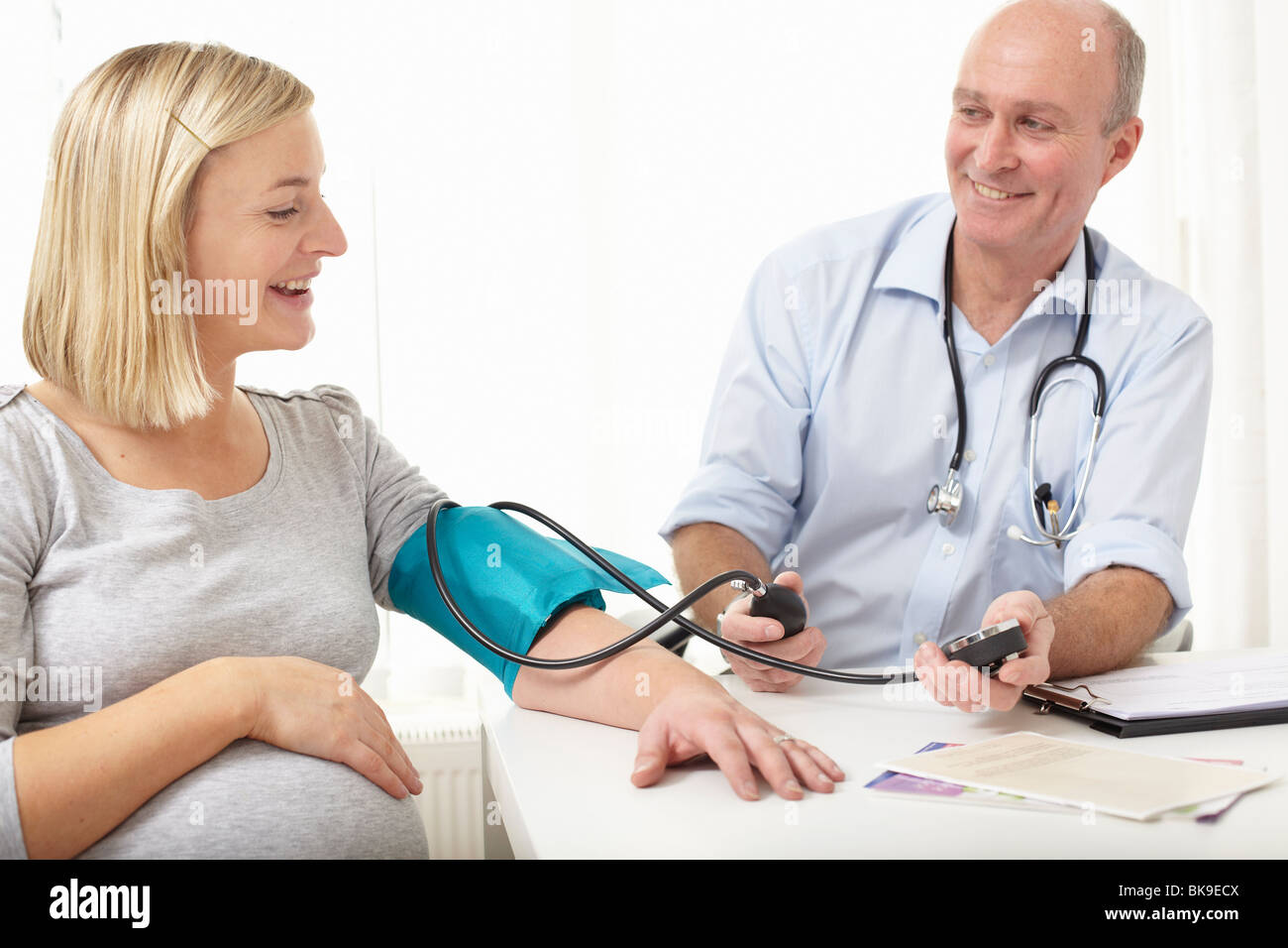 A doctor taking blood pressure Stock Photo - Alamy
