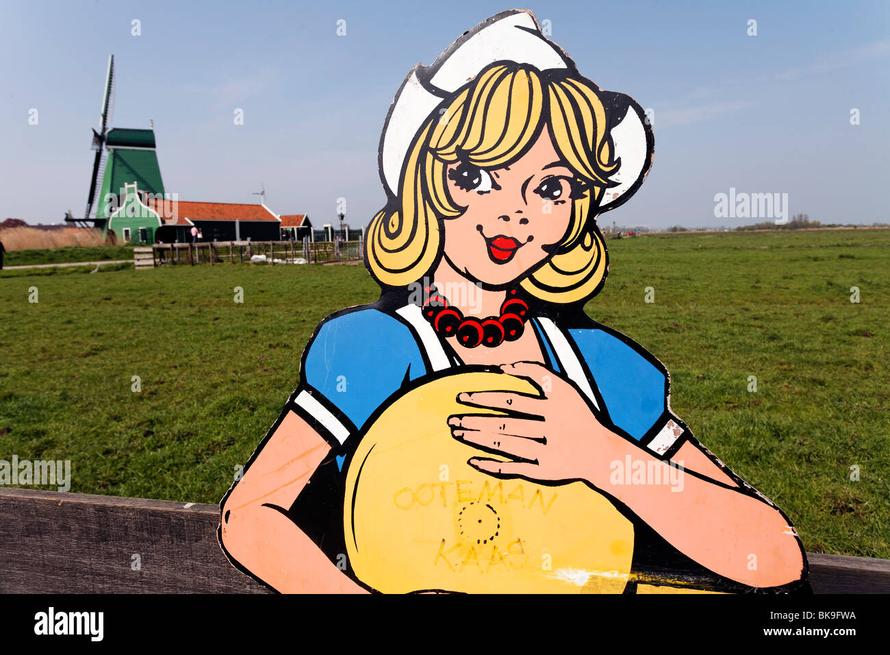 Cardboard cut-out of a Dutch woman in traditional Dutch costume holding cheese, open-air museum Zaanse Schans, Zaanstadt, provi Stock Photo