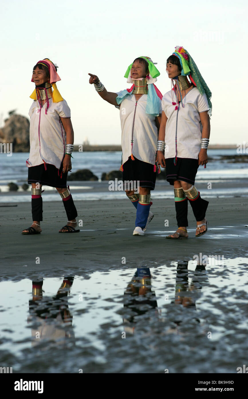 Kayan women Mu Phou, left , Mu Li and Mu La explore the beach in Nelson, New Zealand Stock Photo