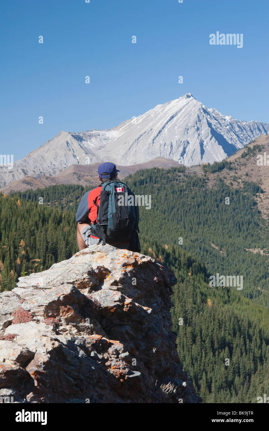 Man Sitting On The Top Of A Mountain Stock Photo - Alamy