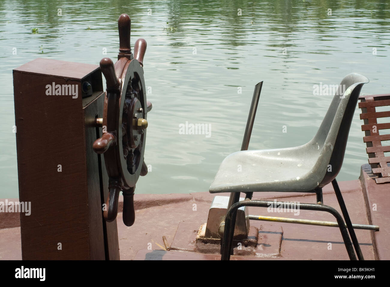 Steering wheel and the drivers seat of a houseboat in kerala Stock Photo