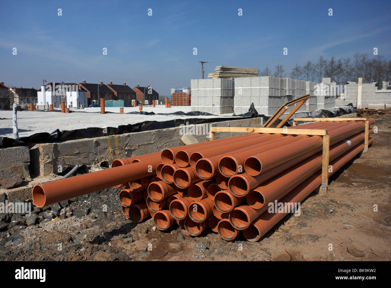 pile of underground sewage and water pipes on construction building site in northern ireland uk Stock Photo