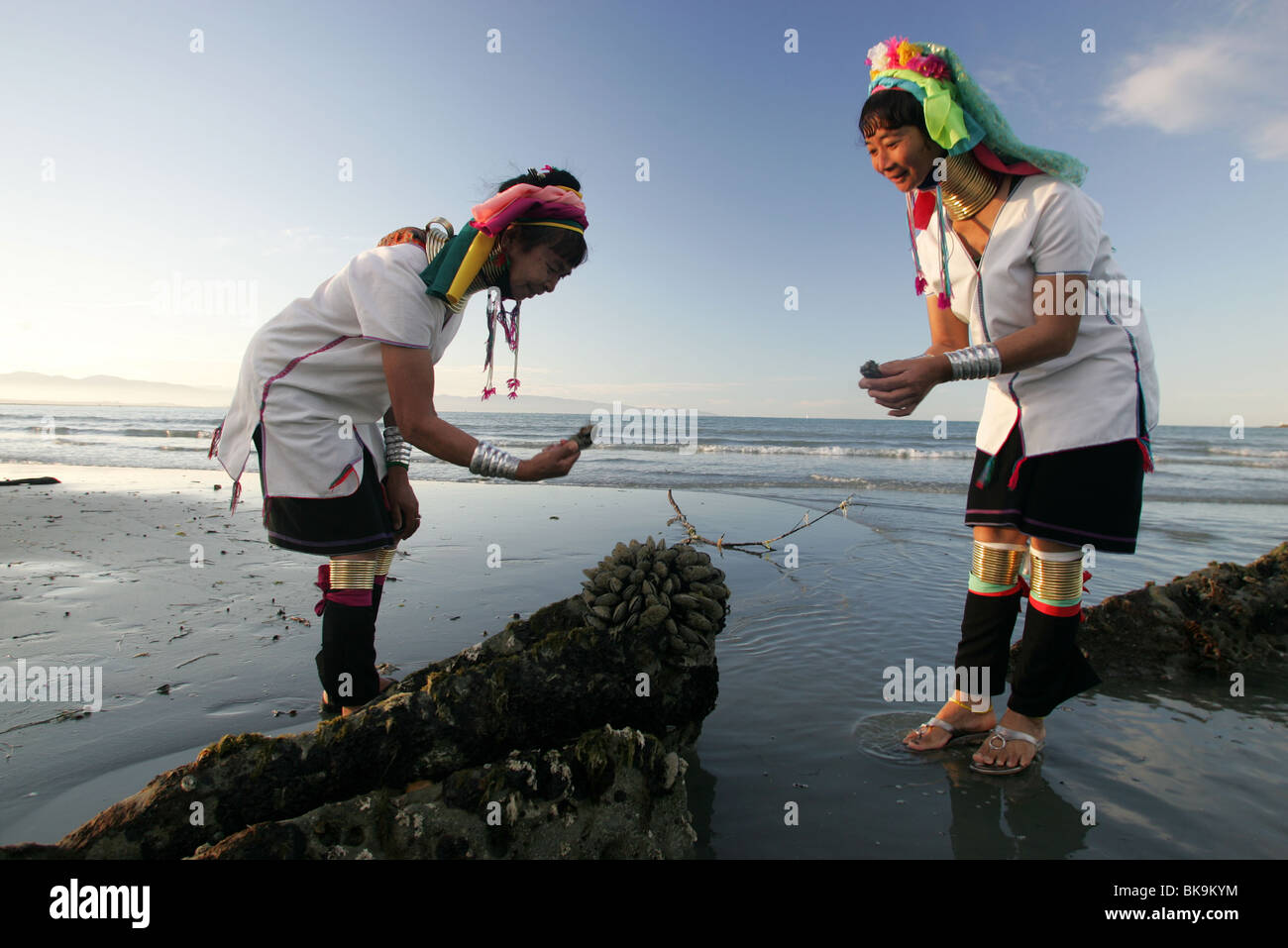 Kayan women Mu Phou, left , and Mu La explore the beach in Nelson, New Zealand Stock Photo