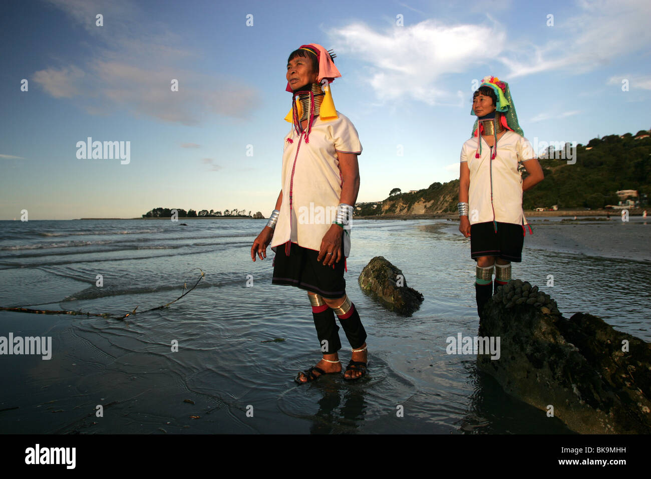 Kayan women Mu Phou, left and Mu La explore the beach in Nelson, New Zealand Stock Photo