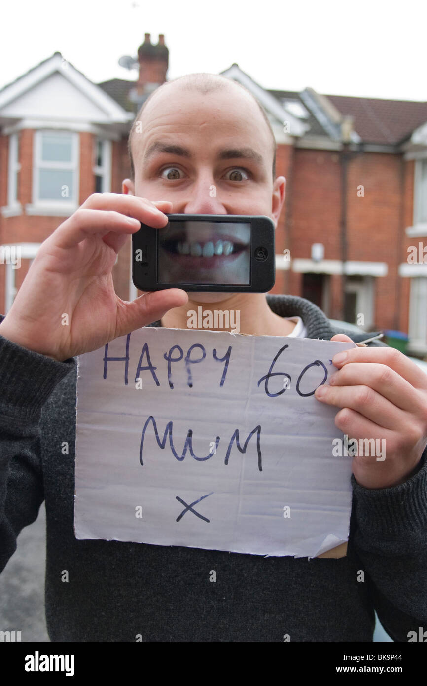 a man holding a happy 60th mum sign stock photo 29103764 alamy
