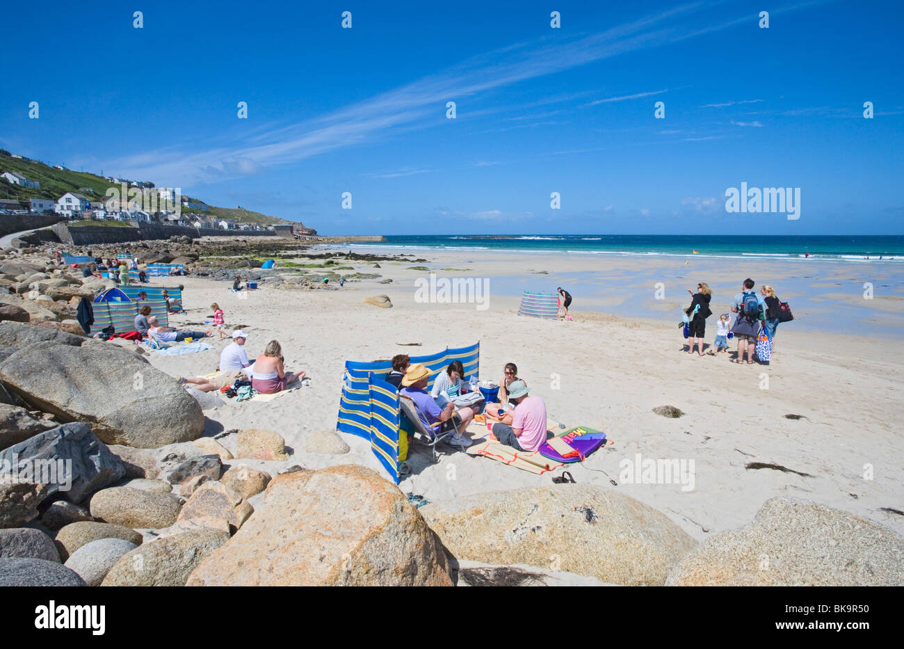 People relaxing at Sennen Cove, Penwith peninsula, Cornwall, England, United Kingdom Stock Photo