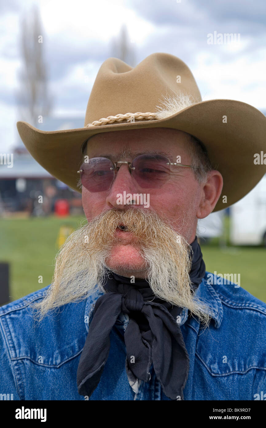 A cowboy with a large mustache at a county fair in Madras, Oregon Stock Photo