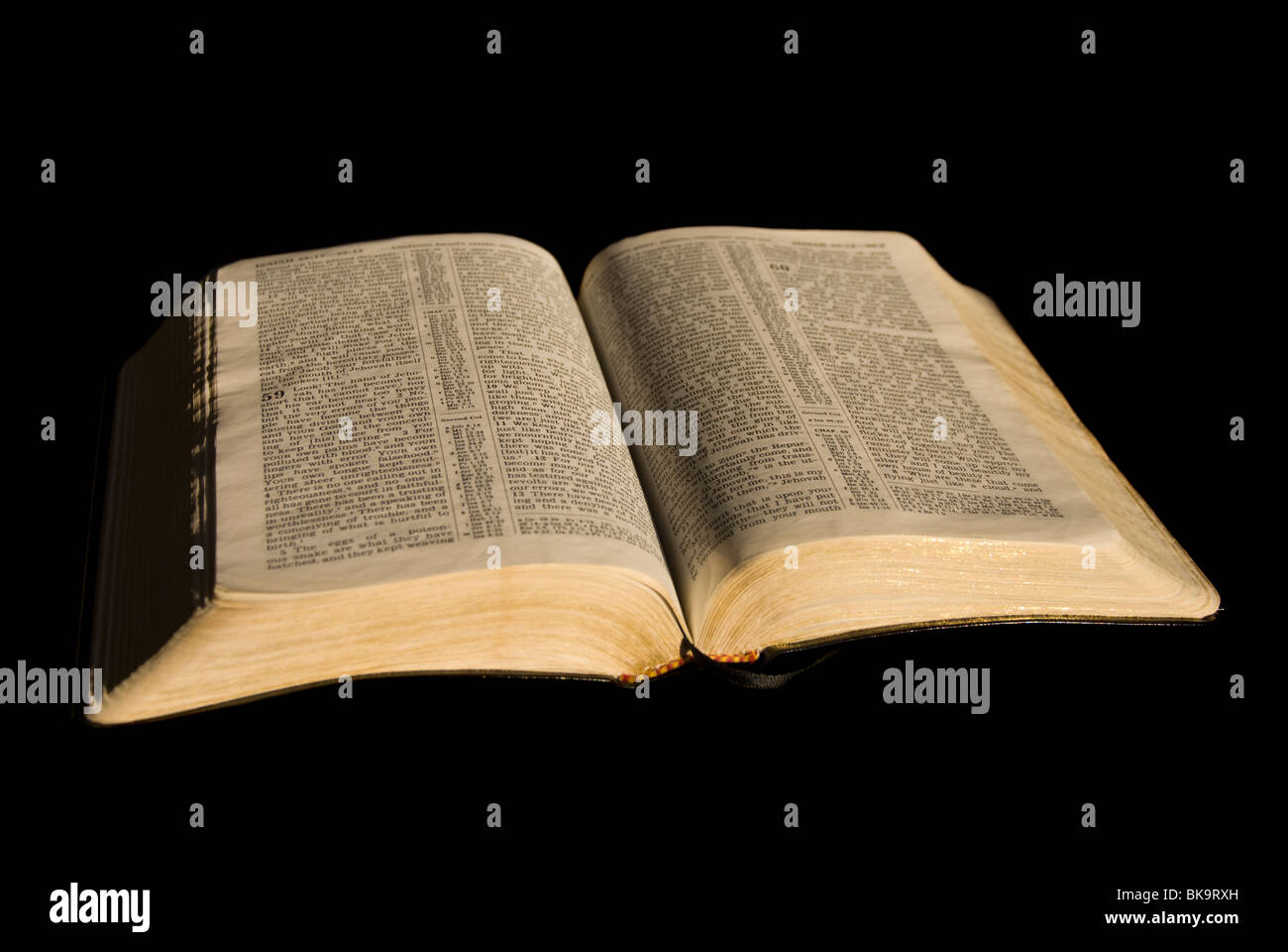 Well-loved Bible glows in golden light Stock Photo