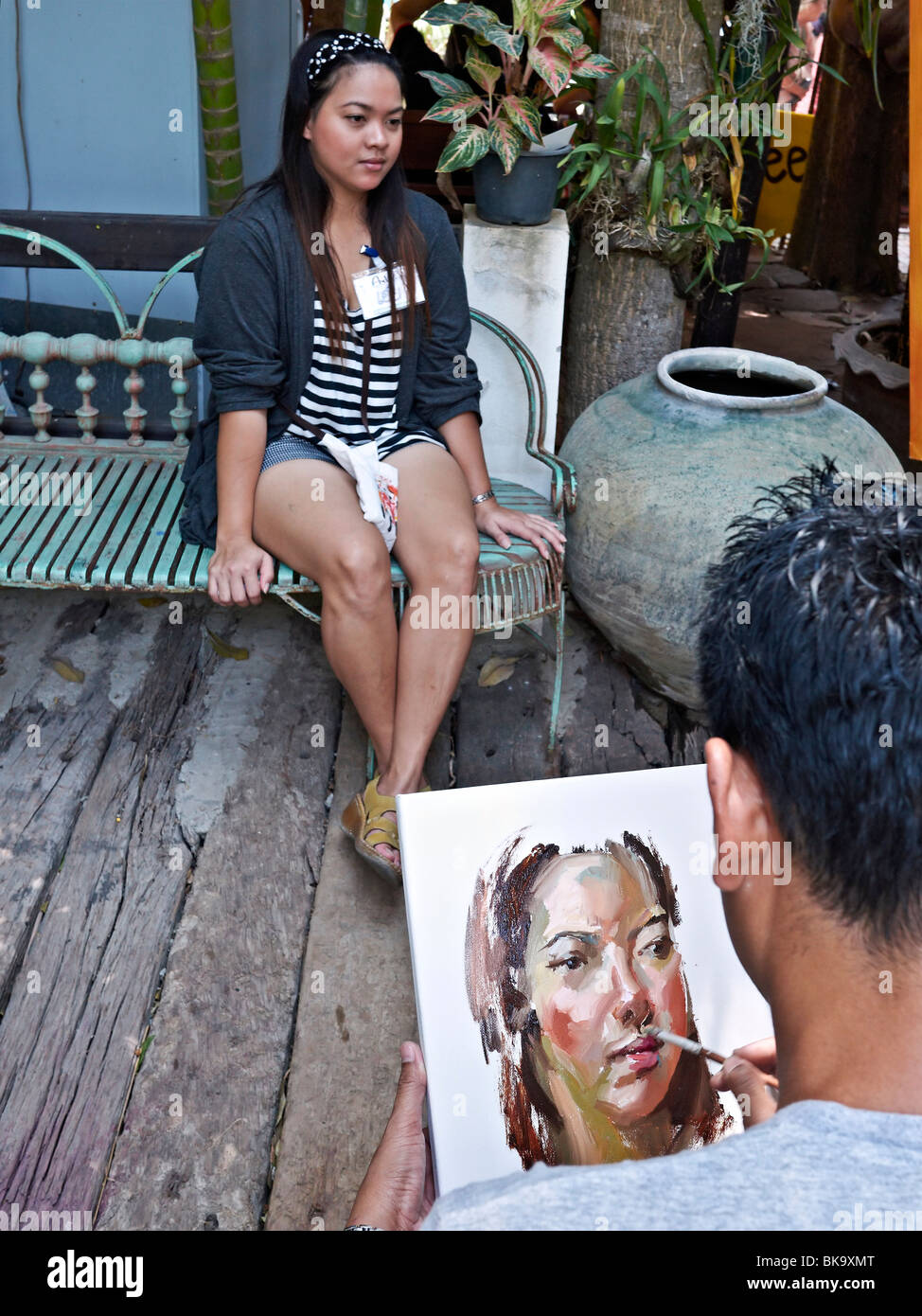 Artist painting a female portrait at an Asian art center. Thailand S. E. Asia Stock Photo