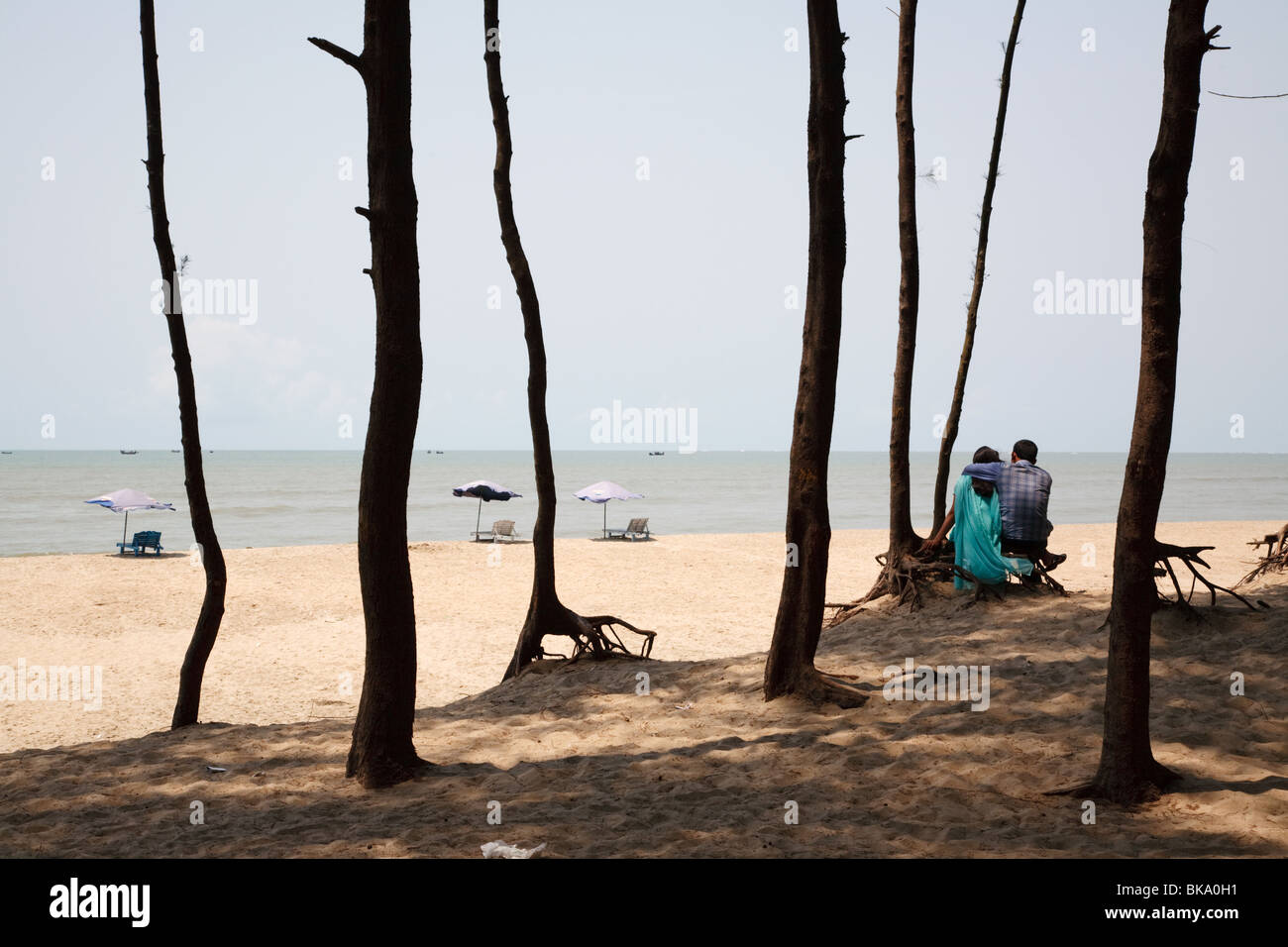 A couple on the beach on the shore of Bay of Bengal in Cox's Bazar, Bangladesh Stock Photo