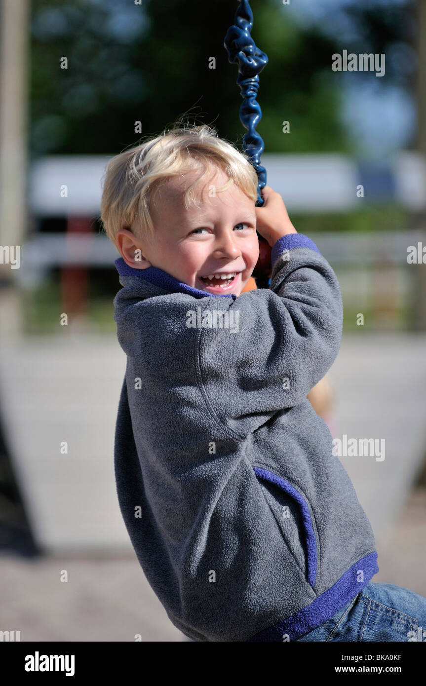 Boy on rope swing, Norrkoeping, Ostergotlands Lan, Sweden Stock Photo