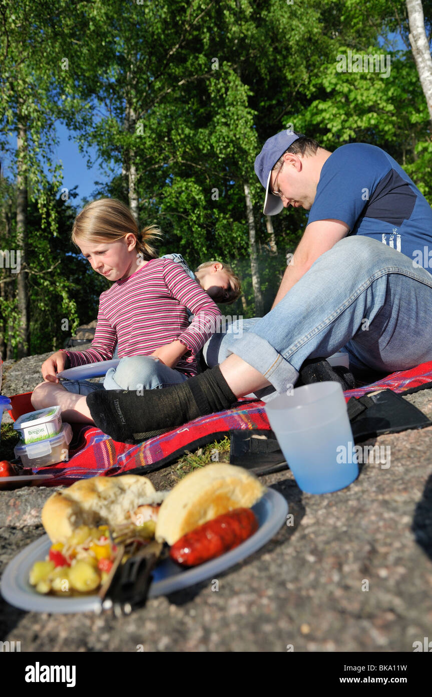 Father and children having a picnic, Norrkoeping, Ostergotlands Lan, Sweden Stock Photo
