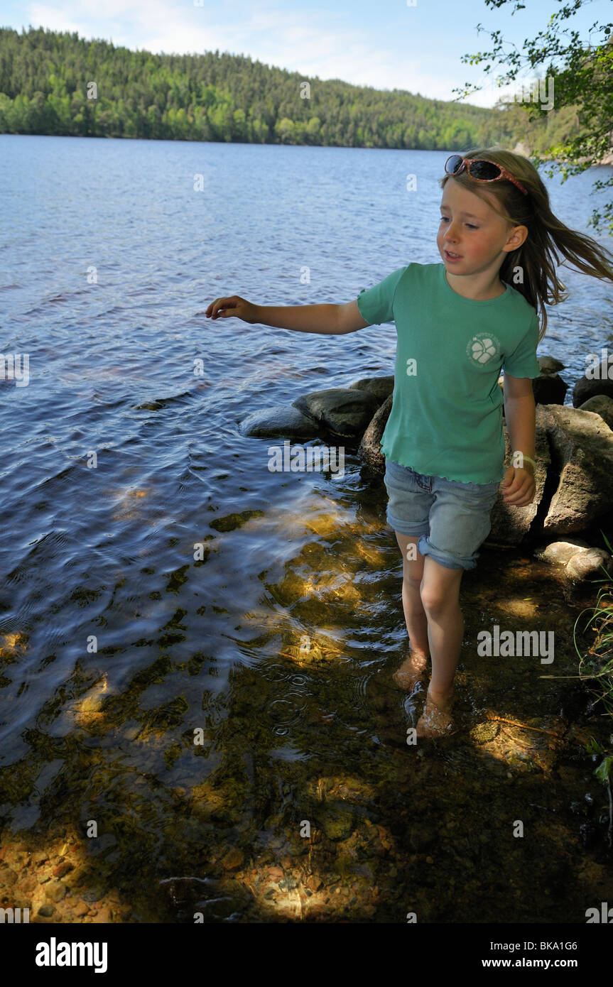 Girl walking along the shore, Norrkoeping, Ostergotlands Lan, Sweden Stock Photo