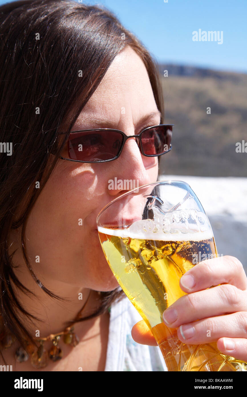 Woman drinking a pint of cider in the sunshine Stock Photo Alamy