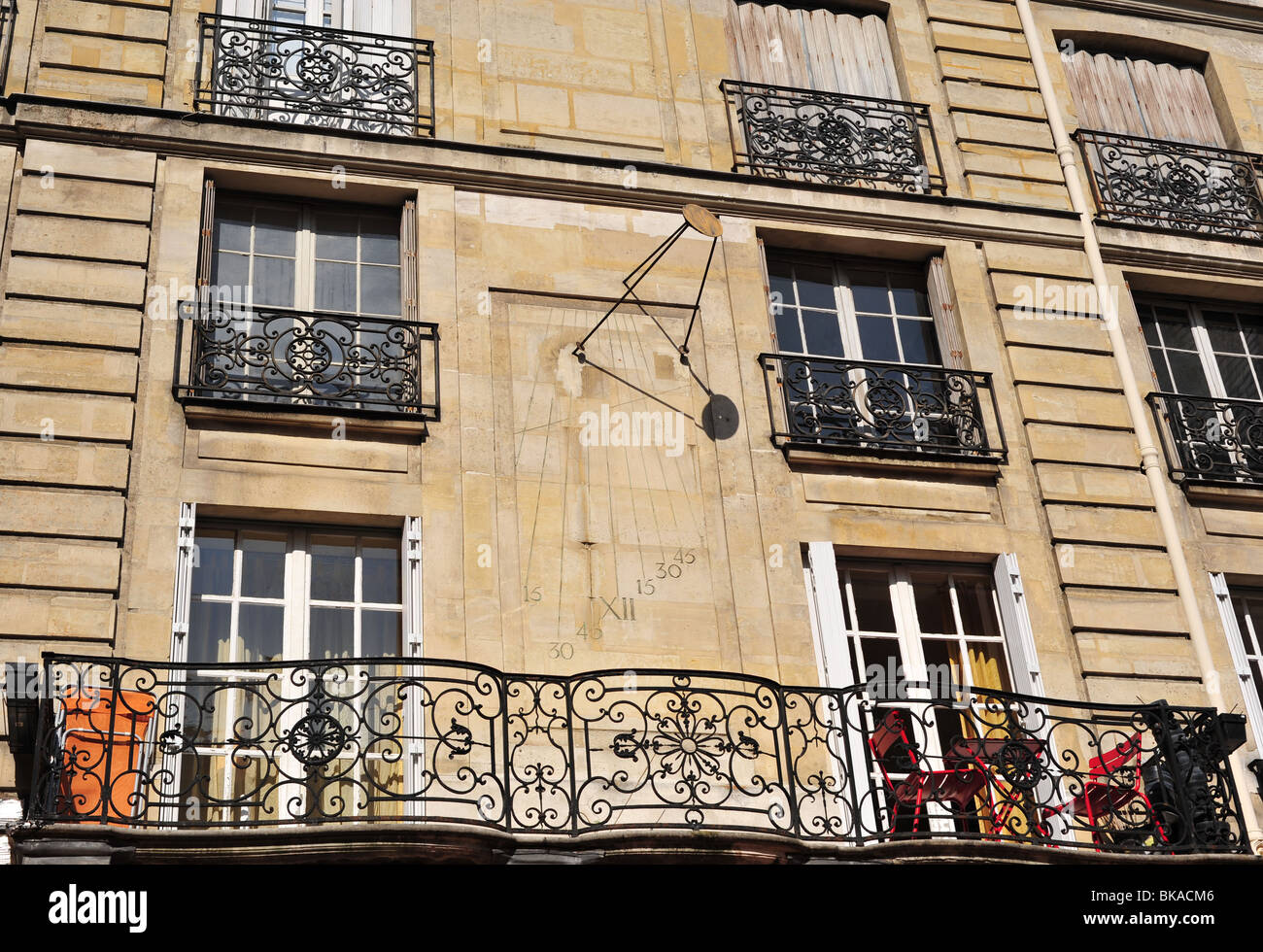 sun clock on a wall in Paris Stock Photo