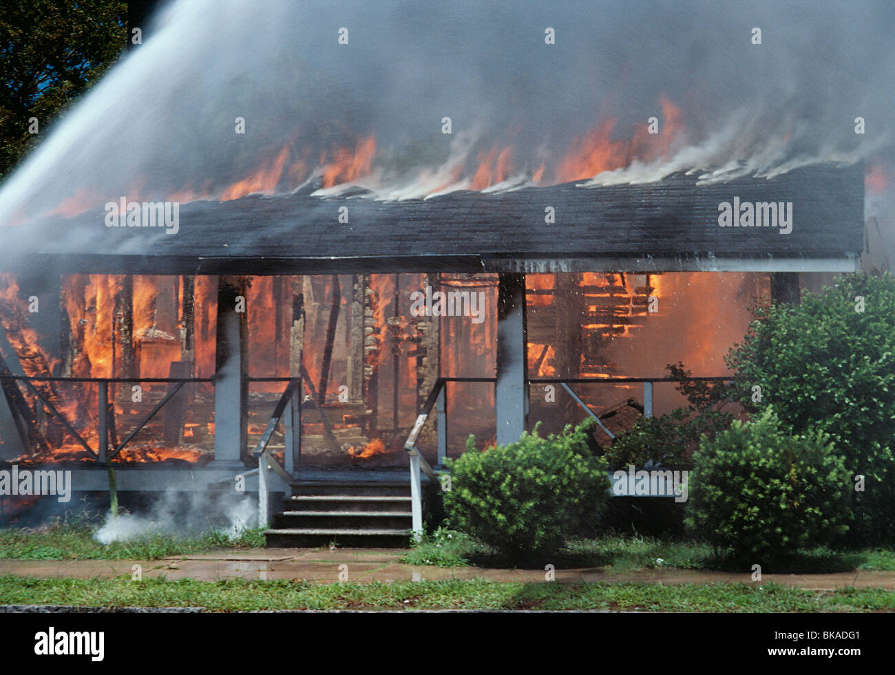 Wooden House Consumed in Flames Stock Photo