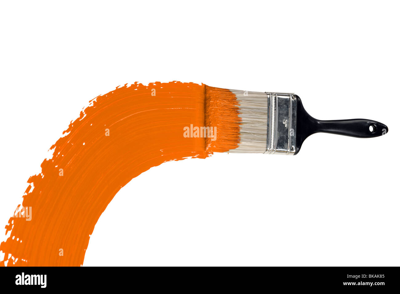 Brush with orange paint isolated over white background Stock Photo