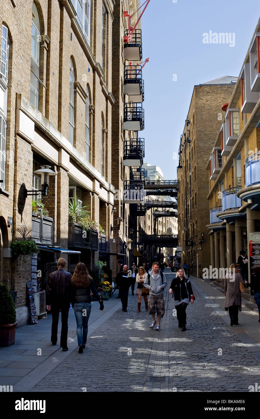 People walking along a street near Shad Thames in London. Photo by