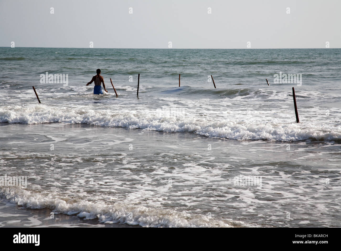 Fisherman on the beach on the shore of Bay of Bengal in Cox's Bazar, Bangladesh Stock Photo