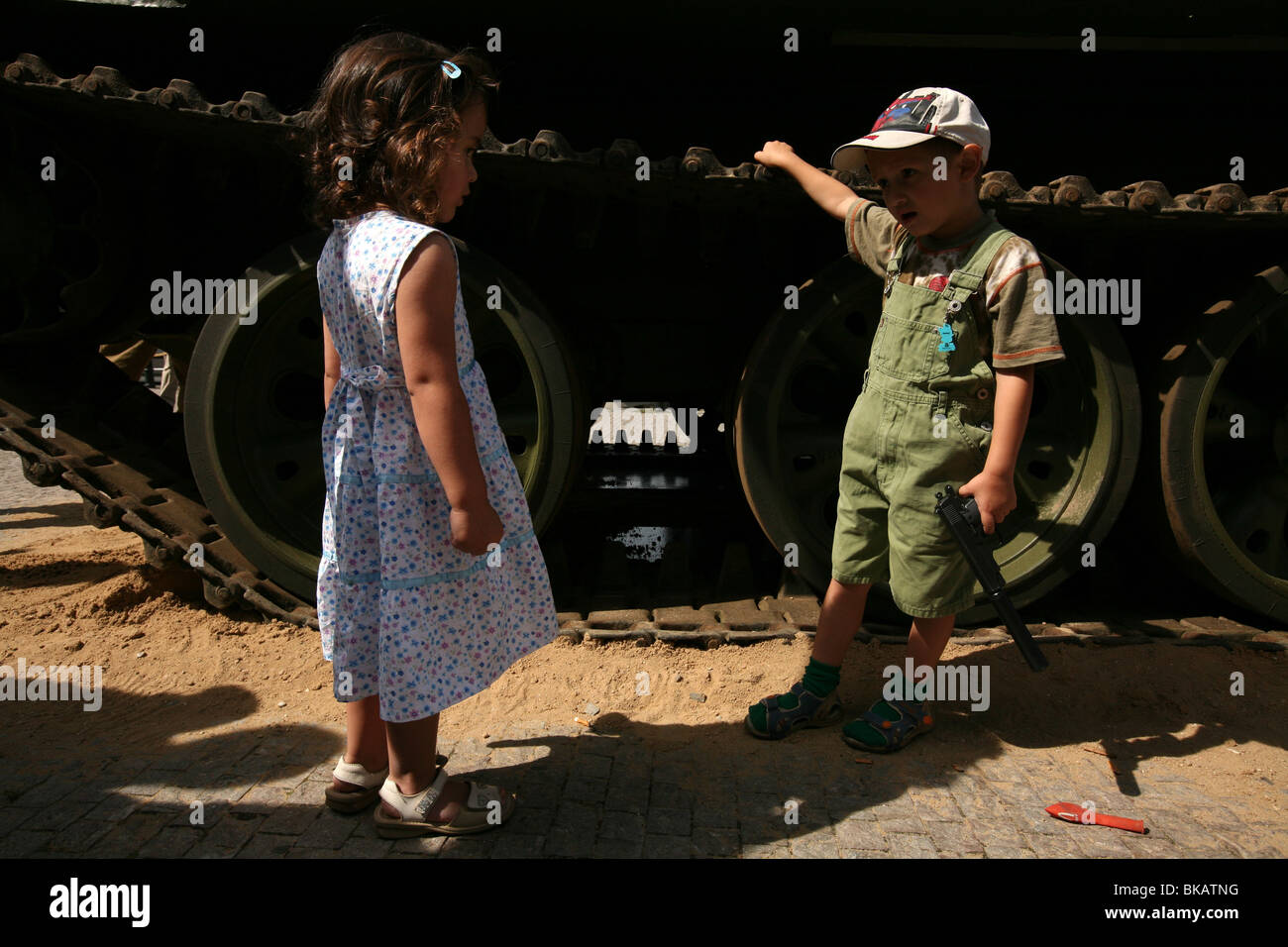 Children play near a Soviet tank that attends the opening of the exhibition in the National Museum in Prague, Czech Republic. Stock Photo