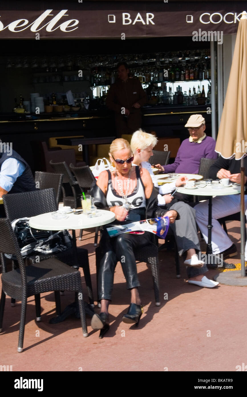 Cannes , La Croisette , mature middle aged lady drinks citron presse at bar  cafe dressed in leather trousers & D&G blouse Stock Photo - Alamy