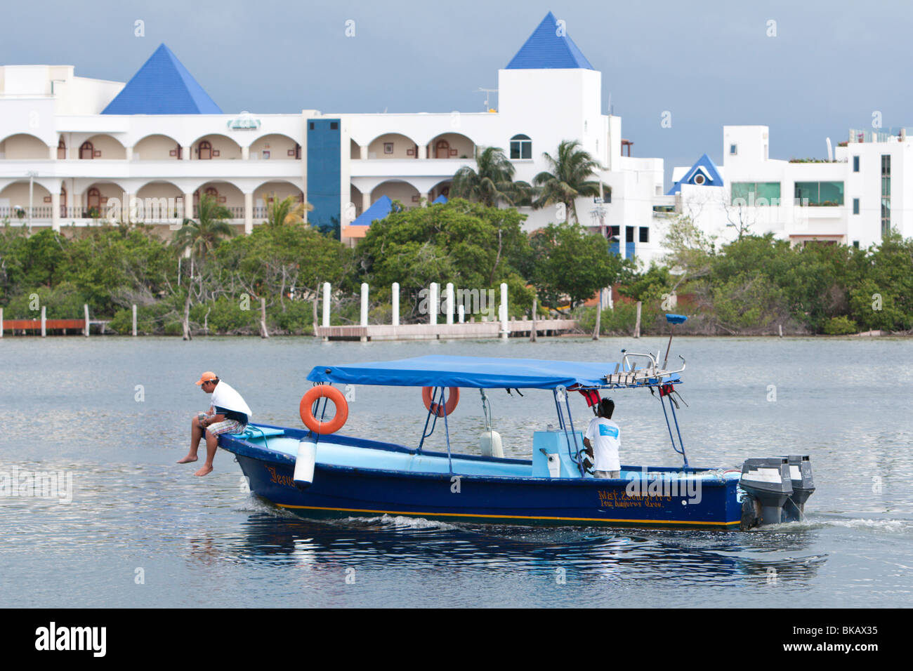 A local fishing/tour boat cruises through the lagoon on the island of Isla Mujeres near Cancun, Mexico Stock Photo