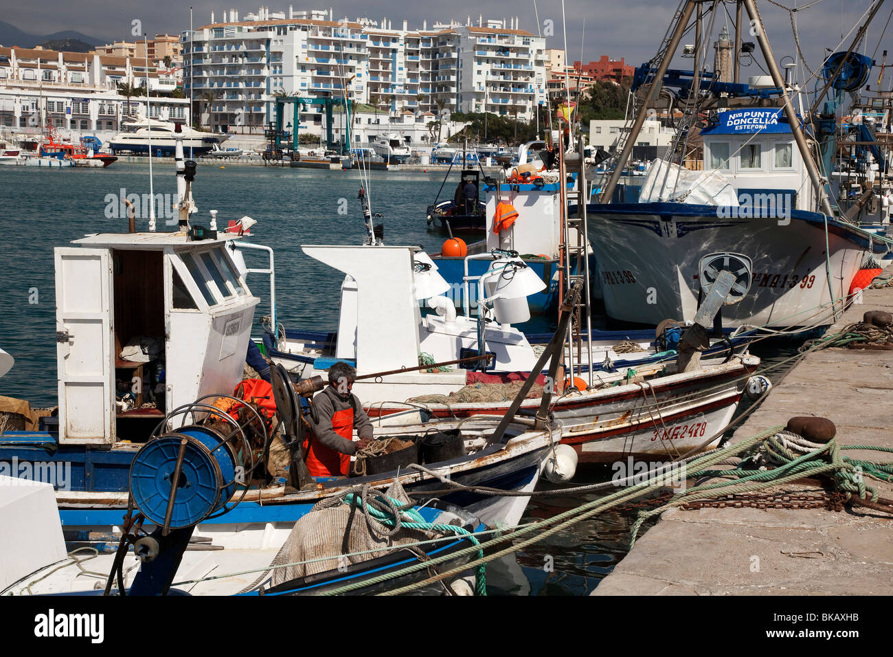 Fisherman removing fish nets in the port of Estepona, Malaga Province,  Andalucia, Spain Stock Photo - Alamy