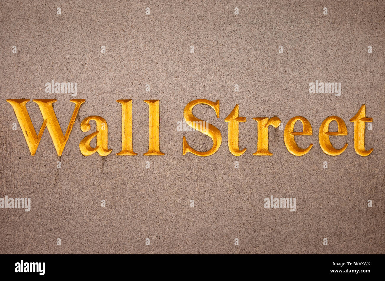Wall Street sign engraved on the wall of a bank building along Wall Street, Lower Manhattan, New York City USA Stock Photo