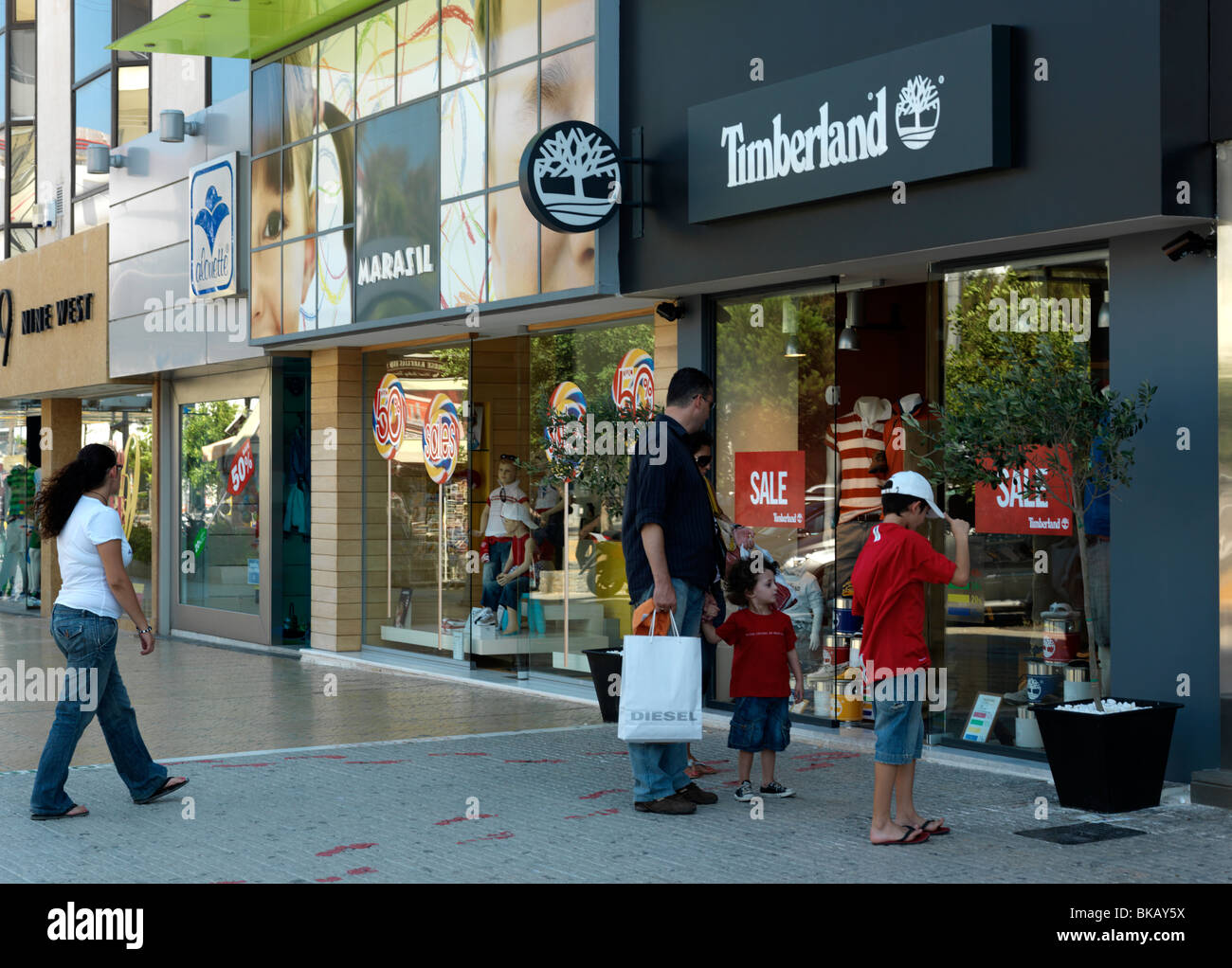 Glyfada Athens Greece Father And Sons Shopping Looking At Timberland Window  During Sales Stock Photo - Alamy