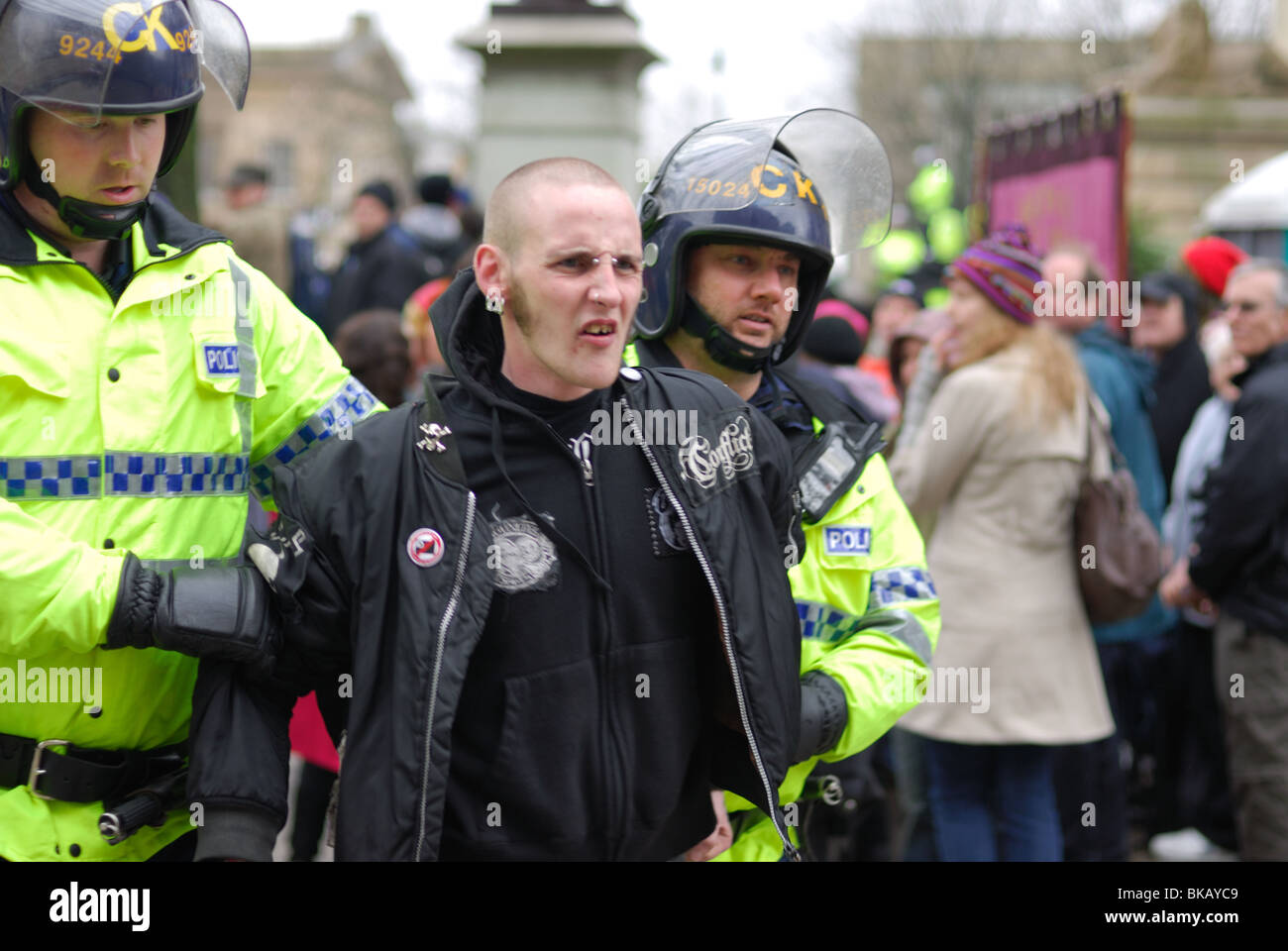 A punk enters Victoria Square to watch the UAF demonstrate against the EDL and is taken away by police for doing nothing. Stock Photo