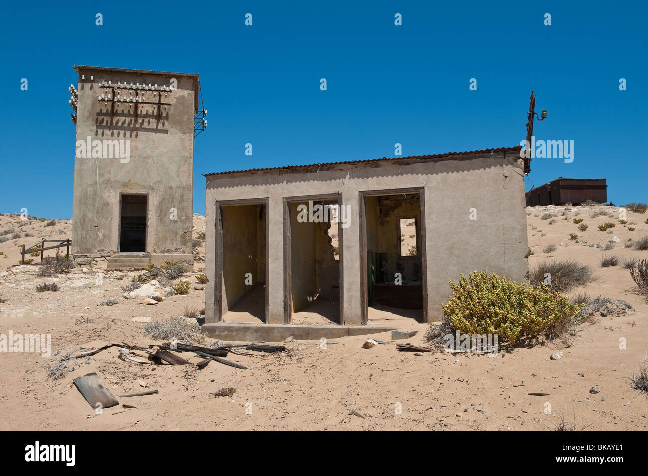 Derelict Toilet Block, Telephone Exchange and Communication Tower in Kolmanskop Ghost Town near Luderitz, Namibia Stock Photo
