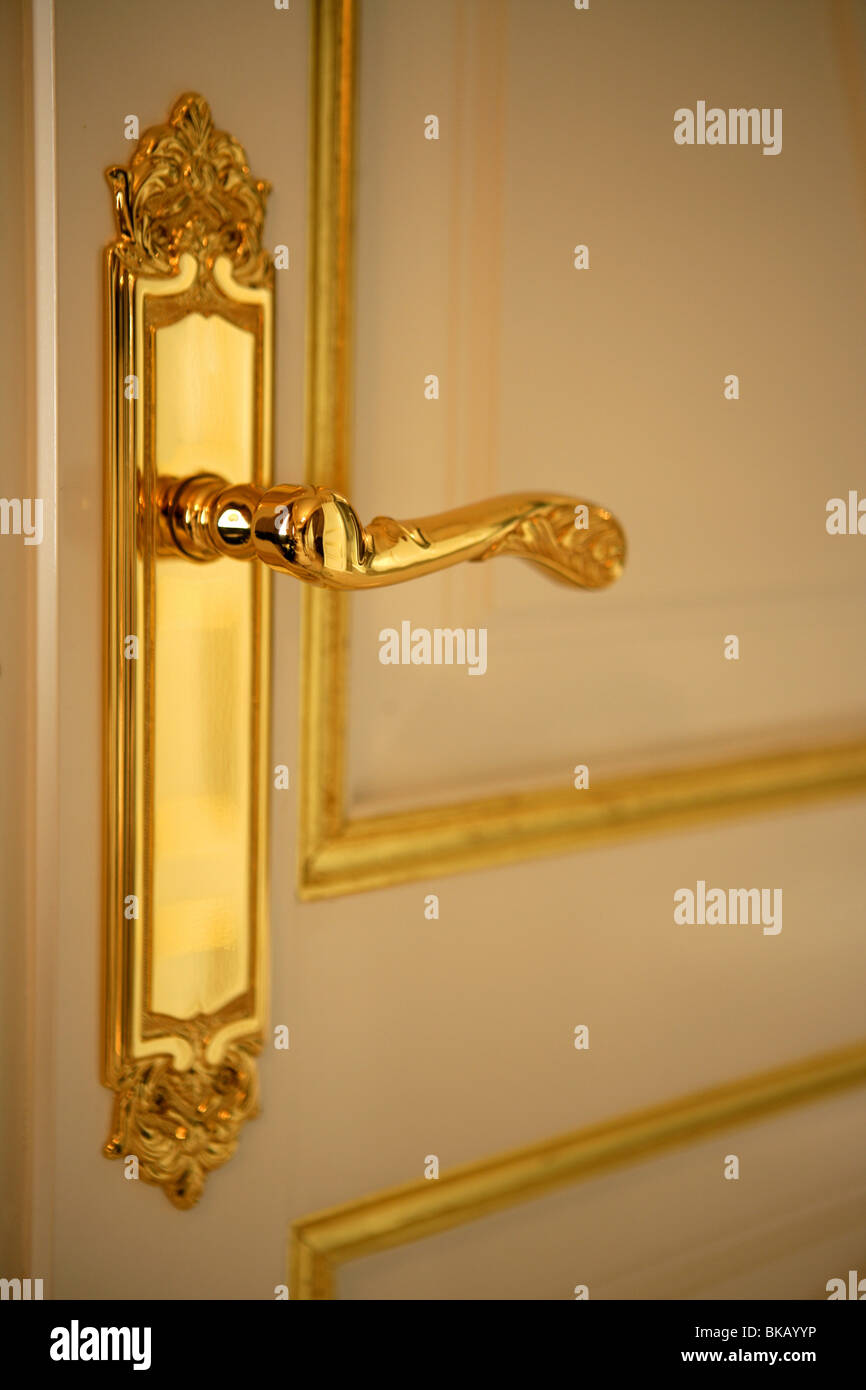 Golden door handle lock, white and gold door Stock Photo Alamy