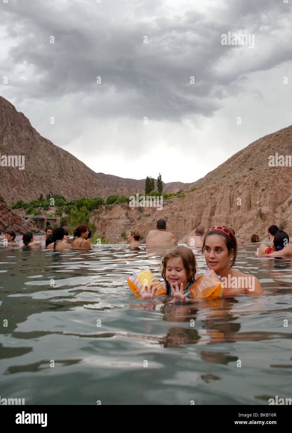 Young girl with her mother enjoying a hot swimming pool in Cacheuta Thermal Springs Resort, Mendoza, Argentina Stock Photo