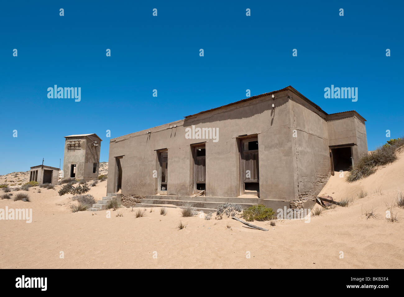 Derelict Toilet Block, Telephone Exchange and Communication Tower in Kolmanskop Ghost Town near Luderitz, Namibia Stock Photo