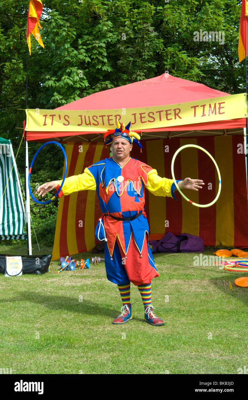 A jester at a fair demonstrating the Hula Hoops Stock Photo