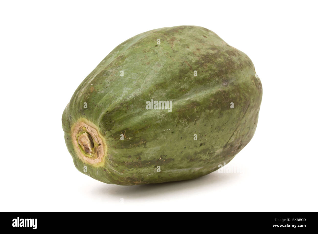 Green Papaya popular in Thai cooking and salads against white background. Stock Photo