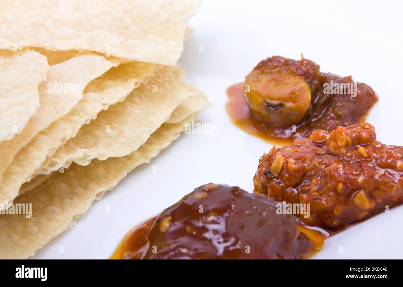 Traditional indian hors d'oeuvres of popadom and spicy pickles. Stock Photo