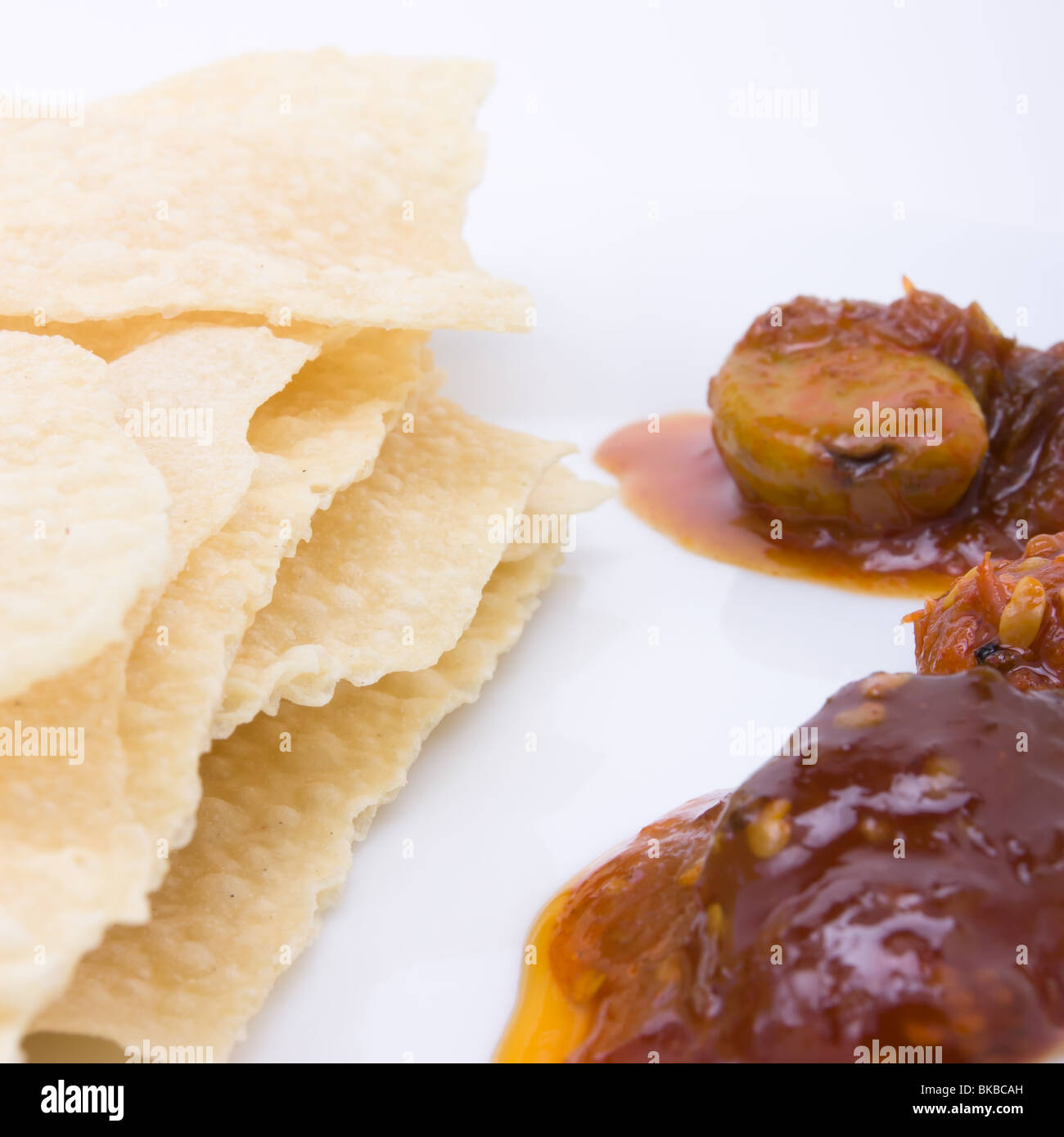 Traditional indian hors d'oeuvres of popadom and spicy pickles. Stock Photo