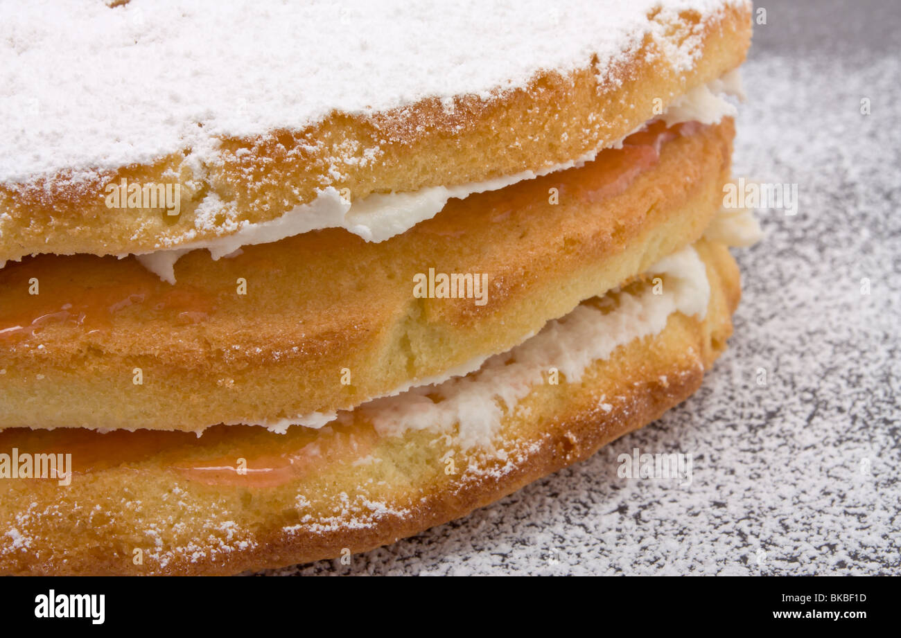Home baked cream and jam Sandwich Cake with dusting of icing sugar Stock Photo