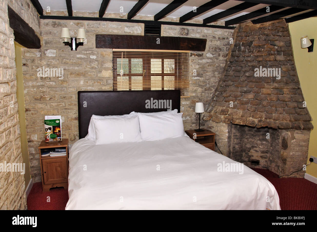 Traditional bedroom, The Hunters Hall Inn, Kingscote, Gloucestershire, England, United Kingdom Stock Photo