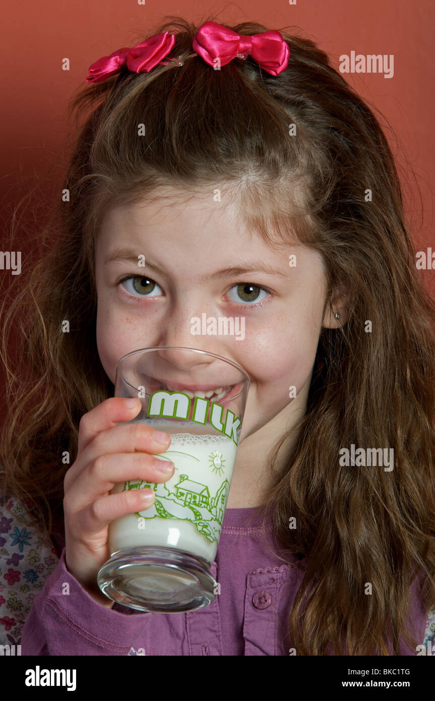 Young girl drinking a glass of milk Stock Photo Alamy