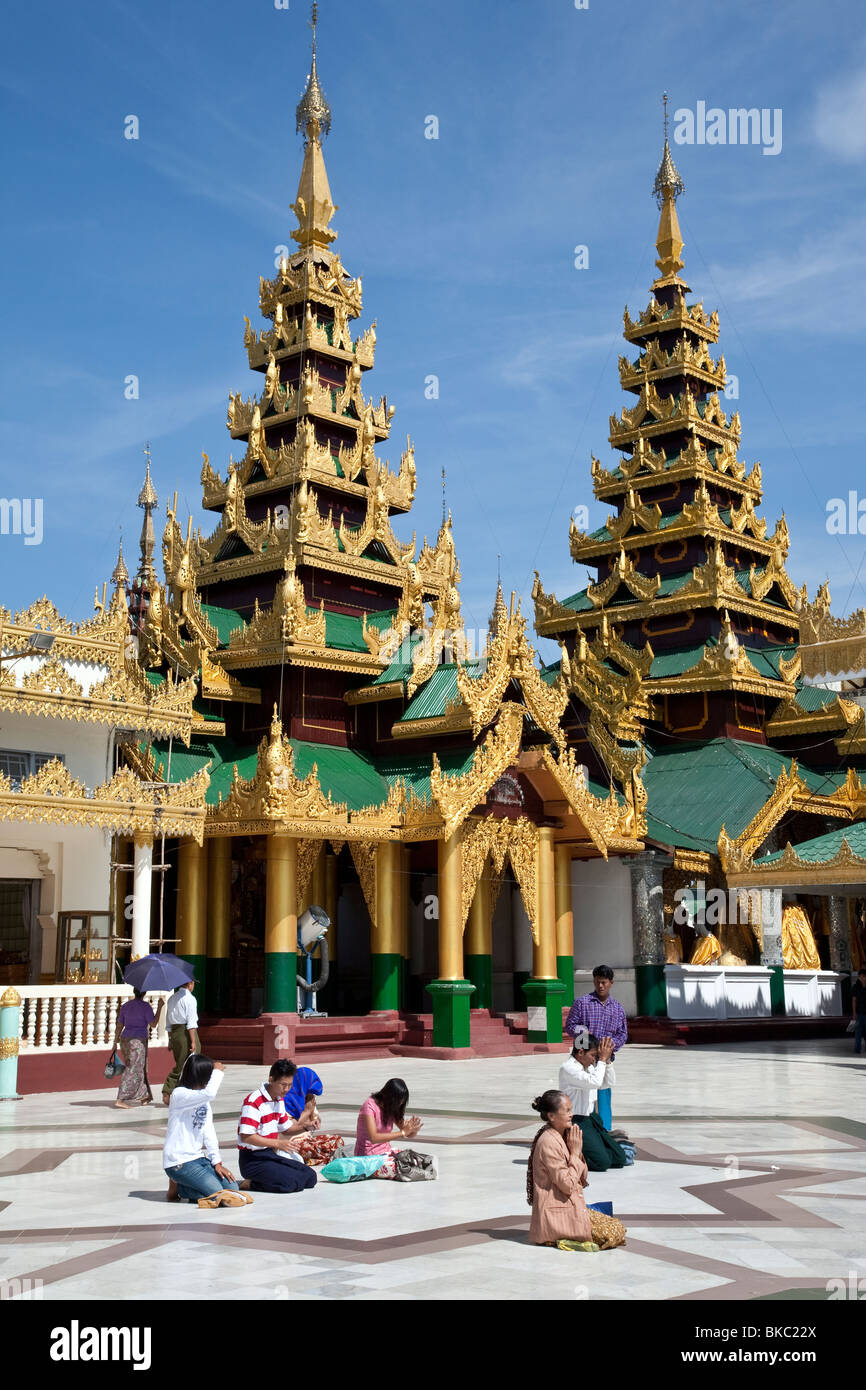 Buddhist devotees praying at Shwedagon Paya. Yangon. Myanmar Stock Photo