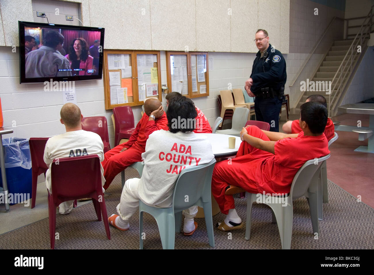 Inmates watch television in the recreational area of a county jail. Stock Photo