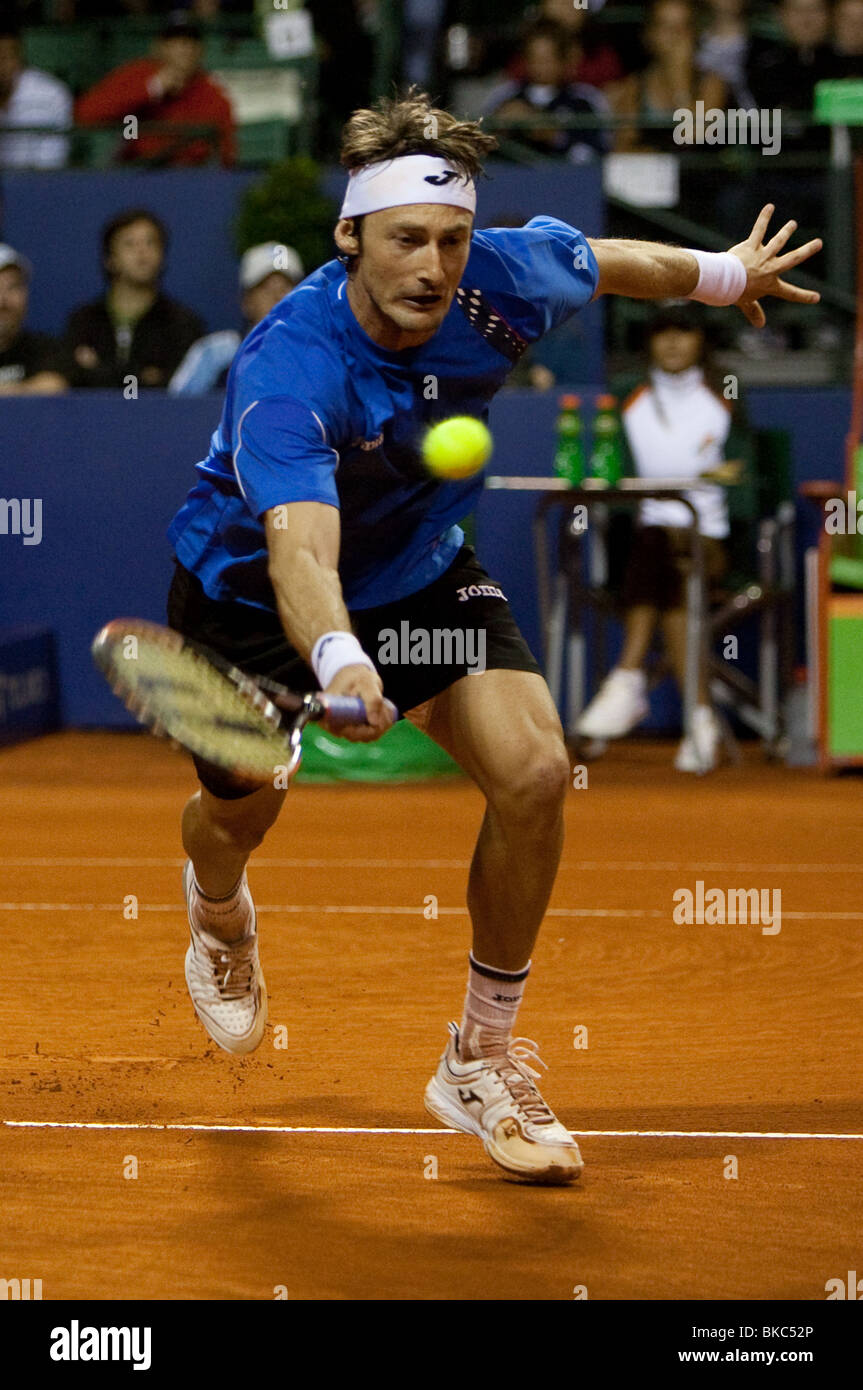 Spanish tennis player Juan Carlos Ferrero stretches to hit a drop shot