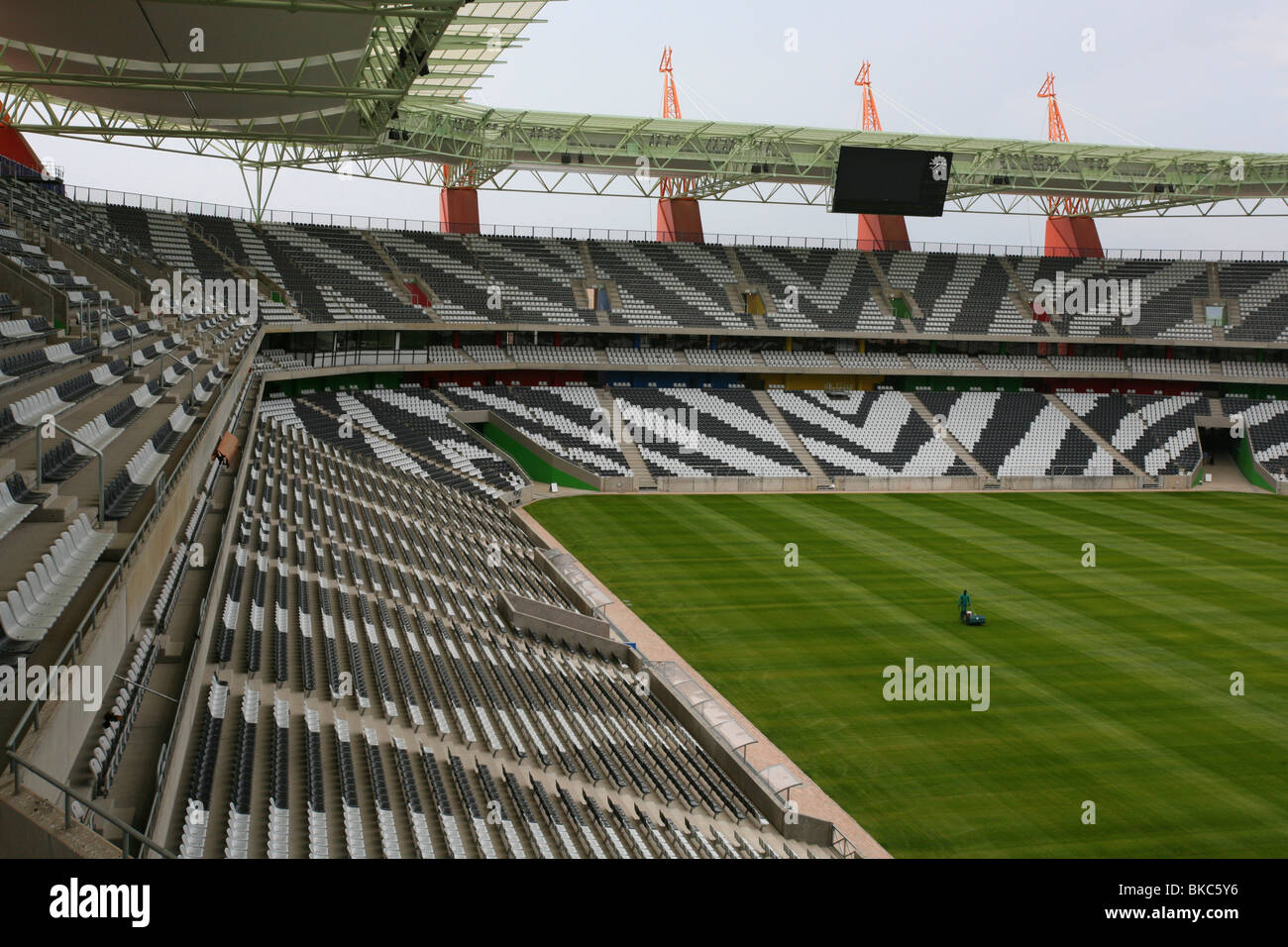 Interior of the Mbombela stadium In Nelspruit  at dusk showing the zebra-striped seating an a lush, green, playing surface Stock Photo