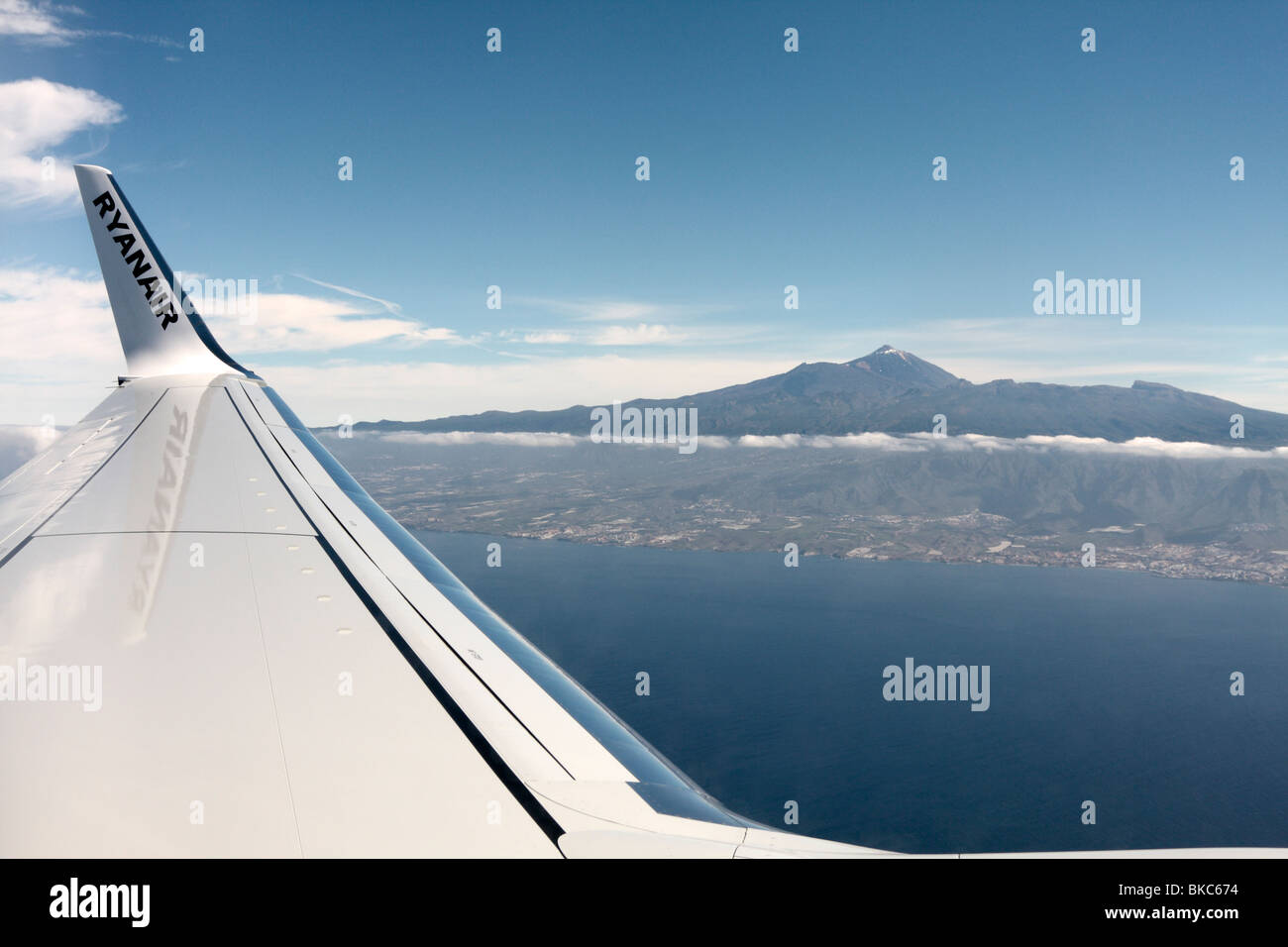 The wing of a Ryanair Boeing 737-800 seen in front of mount Teide on its approach to Tenerife in the Canary Islands Spain Stock Photo