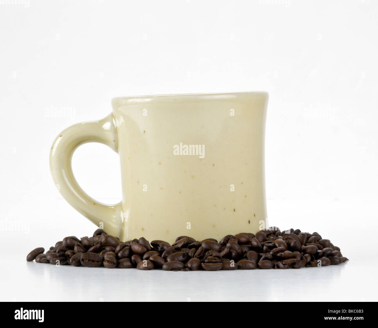 Iconic Coffee Mug in coffee beans on white background Stock Photo