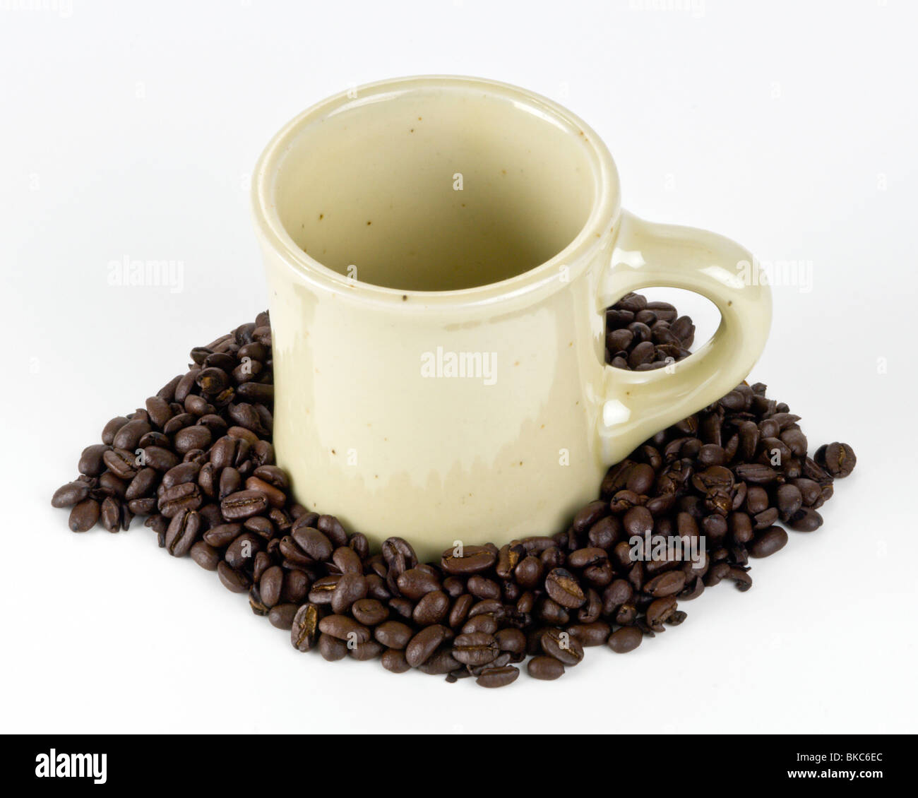 Looking into iconic Coffee Mug in coffee beans on white background Stock Photo