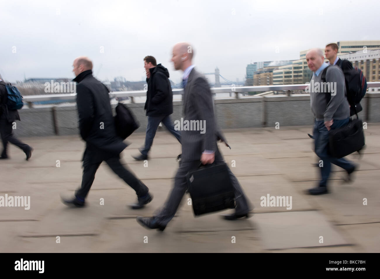 Commuters walking over London Bridge in the early morning rush hour, April 2010, UK Stock Photo