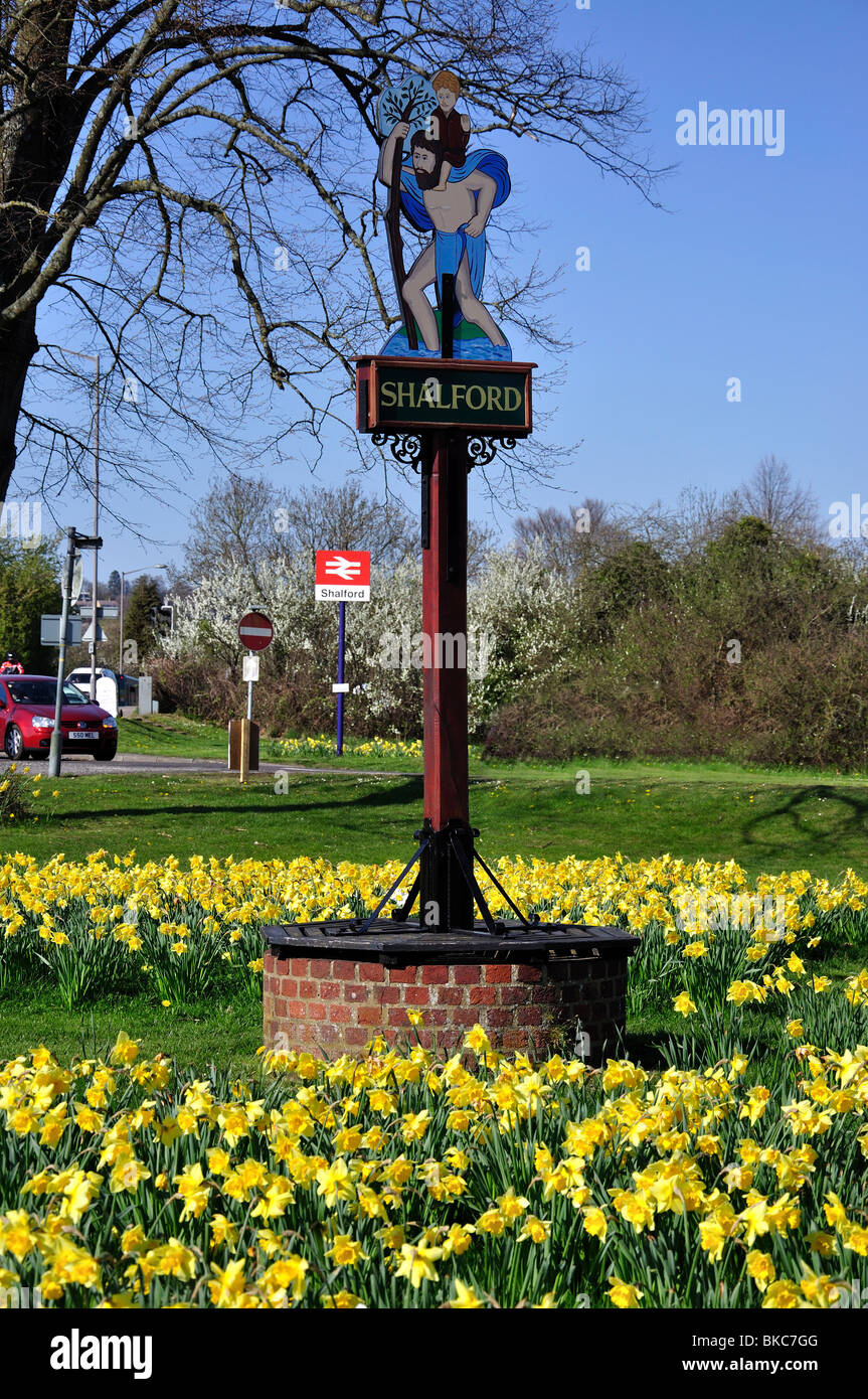 Village sign with daffodils, The Green, Shalford, Surrey, England